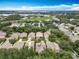 An aerial view of a home in a community with mature trees and a screened pool in the backyard at 12641 Arley Dr, Windermere, FL 34786