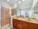 Spacious bathroom with double sink vanity, walk-in shower with tile surround, and large mirror at 12641 Arley Dr, Windermere, FL 34786