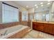 This lovely bathroom features a large tub, enclosed glass shower, and a spacious vanity with double sinks at 12641 Arley Dr, Windermere, FL 34786