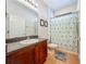 The bathroom features a single sink vanity, toilet, and a shower with a decorative curtain at 12641 Arley Dr, Windermere, FL 34786
