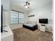 Small bedroom with a daybed, carpeted flooring, and a large window providing natural light at 12641 Arley Dr, Windermere, FL 34786