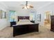 This bedroom features a large bed, a walk-in closet, and a beautiful view at 12641 Arley Dr, Windermere, FL 34786