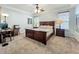This beautiful bedroom has a large window and decorative lamps on either side of the bed at 12641 Arley Dr, Windermere, FL 34786