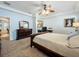 This cozy bedroom features a ceiling fan, a dresser and a desk area for remote work and study at 12641 Arley Dr, Windermere, FL 34786
