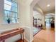 Elegant entryway featuring a console table with plants, arched doorways, and tile flooring at 12641 Arley Dr, Windermere, FL 34786