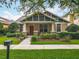 Beautiful home with a covered porch and lush landscaping, offering curb appeal and a welcoming ambiance at 12641 Arley Dr, Windermere, FL 34786