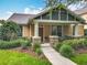 Inviting home featuring a covered porch with stone accents and manicured landscaping enhancing curb appeal at 12641 Arley Dr, Windermere, FL 34786