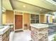 Welcoming covered porch with decorative stone columns and comfortable seating, enhancing curb appeal at 12641 Arley Dr, Windermere, FL 34786