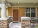 Charming front porch with stone columns and space to relax with outdoor seating at 12641 Arley Dr, Windermere, FL 34786