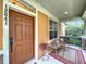 Close-up of a front porch with outdoor seating and a neatly maintained entryway at 12641 Arley Dr, Windermere, FL 34786