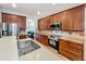 Bright kitchen with stainless steel appliances and ample counter space, flowing into a cozy living space at 12641 Arley Dr, Windermere, FL 34786