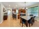 This open kitchen and dining area is complete with tile flooring, stainless appliances, and a modern chandelier at 12641 Arley Dr, Windermere, FL 34786