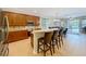 Open kitchen featuring a breakfast bar, stainless steel appliances, and views of the outdoor pool at 12641 Arley Dr, Windermere, FL 34786