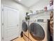 Laundry room with side-by-side, front load washer and dryer, with shelving above at 12641 Arley Dr, Windermere, FL 34786