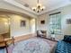 Inviting sitting area with a comfortable chair, desk, and ample natural light at 12641 Arley Dr, Windermere, FL 34786