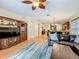View of the living room with a large sofa, media center, and a view into the kitchen and dining room at 12641 Arley Dr, Windermere, FL 34786