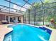 Inviting screened-in pool area perfect for relaxation and entertainment; features a beautifully tiled pool and lush landscaping at 12641 Arley Dr, Windermere, FL 34786