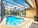 Beautiful screened-in pool with tile and landscaping providing a private backyard oasis at 12641 Arley Dr, Windermere, FL 34786