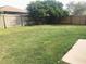 Spacious backyard features a well-maintained lawn and a tall wooden fence at 10513 Leader Ln, Orlando, FL 32825