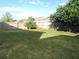A backyard featuring a well-maintained lawn enclosed by a wooden fence at 10513 Leader Ln, Orlando, FL 32825