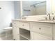 Bright bathroom featuring double sink vanity with granite countertop and modern fixtures at 10513 Leader Ln, Orlando, FL 32825