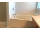 A bright bathroom featuring a soaking tub at 10513 Leader Ln, Orlando, FL 32825