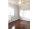 Sunlit bedroom with hardwood floors and ample space, offering a serene retreat at 10513 Leader Ln, Orlando, FL 32825