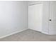 A simple bedroom showcasing carpet, a closet, and neutral paint at 10513 Leader Ln, Orlando, FL 32825