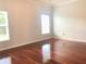 A bright bedroom with hardwood floors and natural light from the large windows at 10513 Leader Ln, Orlando, FL 32825