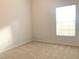Bedroom featuring neutral carpet, window bringing natural light, and a ceiling fan at 10513 Leader Ln, Orlando, FL 32825