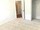 Bright bedroom featuring neutral carpeting, closet, and an adjoining open doorway at 10513 Leader Ln, Orlando, FL 32825