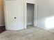 Well-lit bedroom with carpet, a closet with folding doors, and neutral walls at 10513 Leader Ln, Orlando, FL 32825