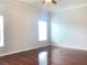 Spacious bedroom featuring hardwood floors, ceiling fan, and natural light from large window at 10513 Leader Ln, Orlando, FL 32825