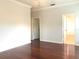 A bright bedroom with hardwood floors and views to two bathrooms at 10513 Leader Ln, Orlando, FL 32825