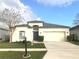 Charming single-story home with a well-manicured lawn, a two-car garage and welcoming curb appeal at 10513 Leader Ln, Orlando, FL 32825