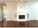 Elegant fireplace with built-in shelves and hardwood floors, enhancing the room's charm at 10513 Leader Ln, Orlando, FL 32825