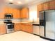 Bright kitchen featuring stainless steel appliances and light wood cabinetry at 10513 Leader Ln, Orlando, FL 32825