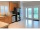 Bright kitchen with stainless steel appliances and access to the backyard through glass doors at 10513 Leader Ln, Orlando, FL 32825