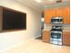 Bright kitchen featuring stainless steel appliances, light wood cabinetry and a black chalkboard at 10513 Leader Ln, Orlando, FL 32825