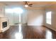 Open living room with hardwood floors, fireplace, and ample natural light, creating a warm atmosphere at 10513 Leader Ln, Orlando, FL 32825