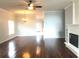 Cozy living room featuring hardwood floors, ceiling fan, and a fireplace, offering a comfortable ambiance at 10513 Leader Ln, Orlando, FL 32825