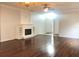 Spacious living room with hardwood floors and a fireplace, ideal for relaxation and entertaining at 10513 Leader Ln, Orlando, FL 32825