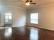 Bright and spacious living room with hardwood floors and a large window, perfect for relaxation at 10513 Leader Ln, Orlando, FL 32825