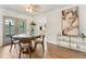 Bright dining area with modern decor, wood floors, and seamless access to the kitchen at 108 Devon Ct, Longwood, FL 32779