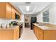 Modern kitchen with stainless steel appliances, wood cabinets, and granite countertops, ideal for cooking at 108 Devon Ct, Longwood, FL 32779
