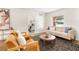 Inviting living room with wood flooring, comfortable seating, and a view into a bedroom at 108 Devon Ct, Longwood, FL 32779