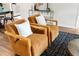 Cozy living room featuring stylish armchairs, decor, wood flooring, and natural light at 108 Devon Ct, Longwood, FL 32779