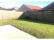 Well-maintained backyard with a concrete patio and a wooden fence, offering privacy at 10969 Norcross Cir, Orlando, FL 32825