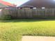 Backyard with a green lawn and a wooden fence, perfect for outdoor activities and privacy at 10969 Norcross Cir, Orlando, FL 32825