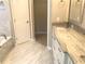 Beautifully renovated bathroom featuring marble floors and a granite countertop at 10969 Norcross Cir, Orlando, FL 32825